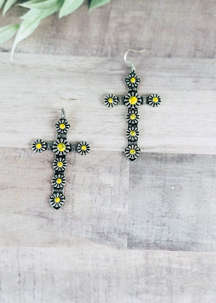 Yellow Western Concho Cross Earrings on wood background with green decor