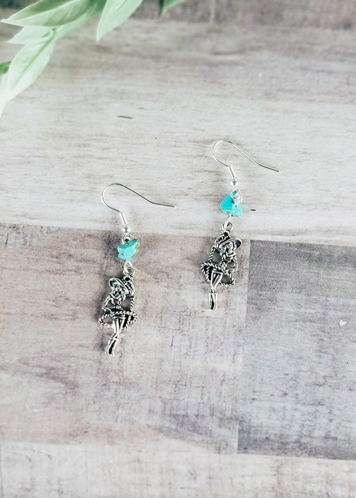 Vintage Cowgirl and Turquoise Earrings on wood background with green decor in corner