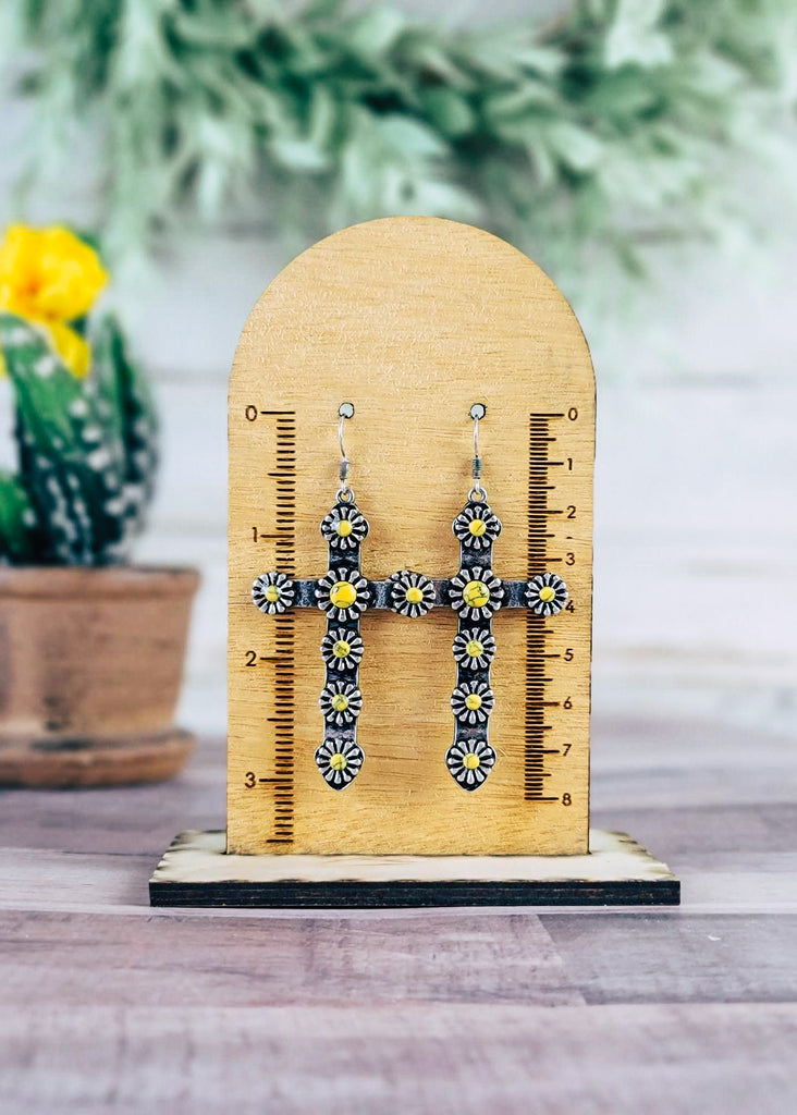 Yellow Western Concho Cross Earrings on wood background with green decor on wood measurement hanging