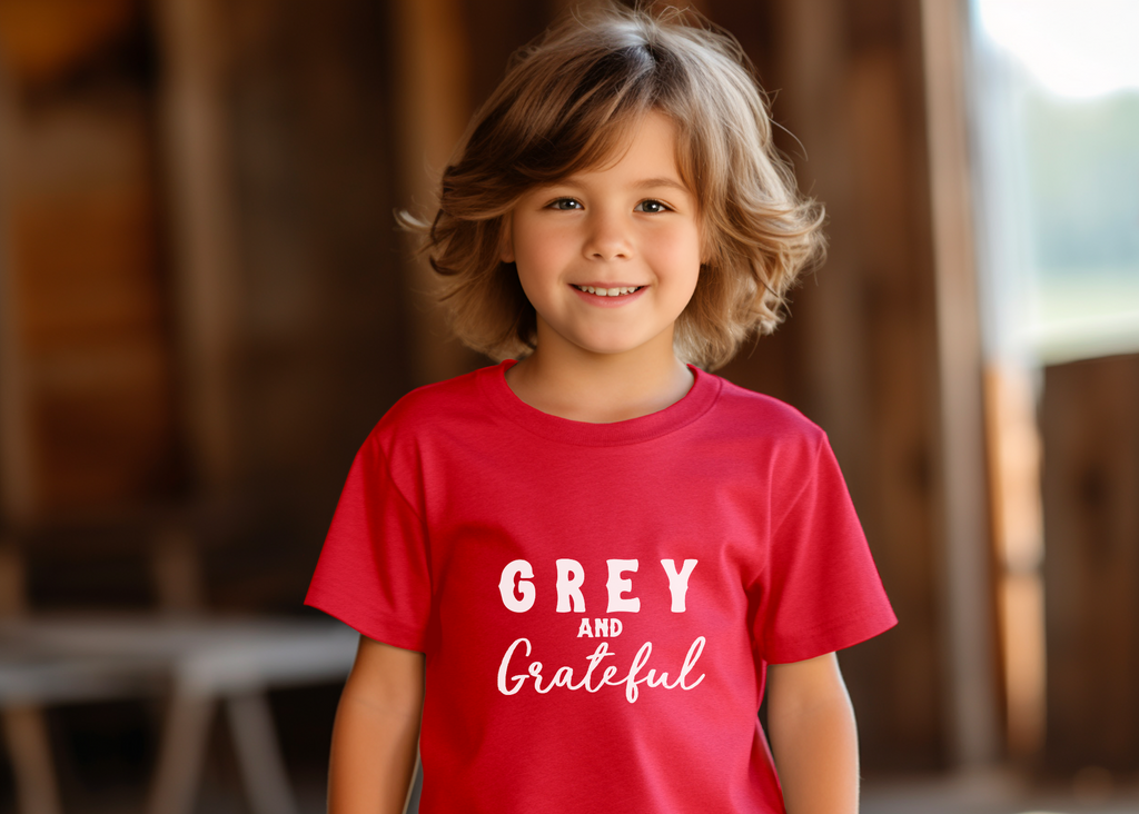 Red youth short sleeve with white lettering reading "Grey and Grateful". 