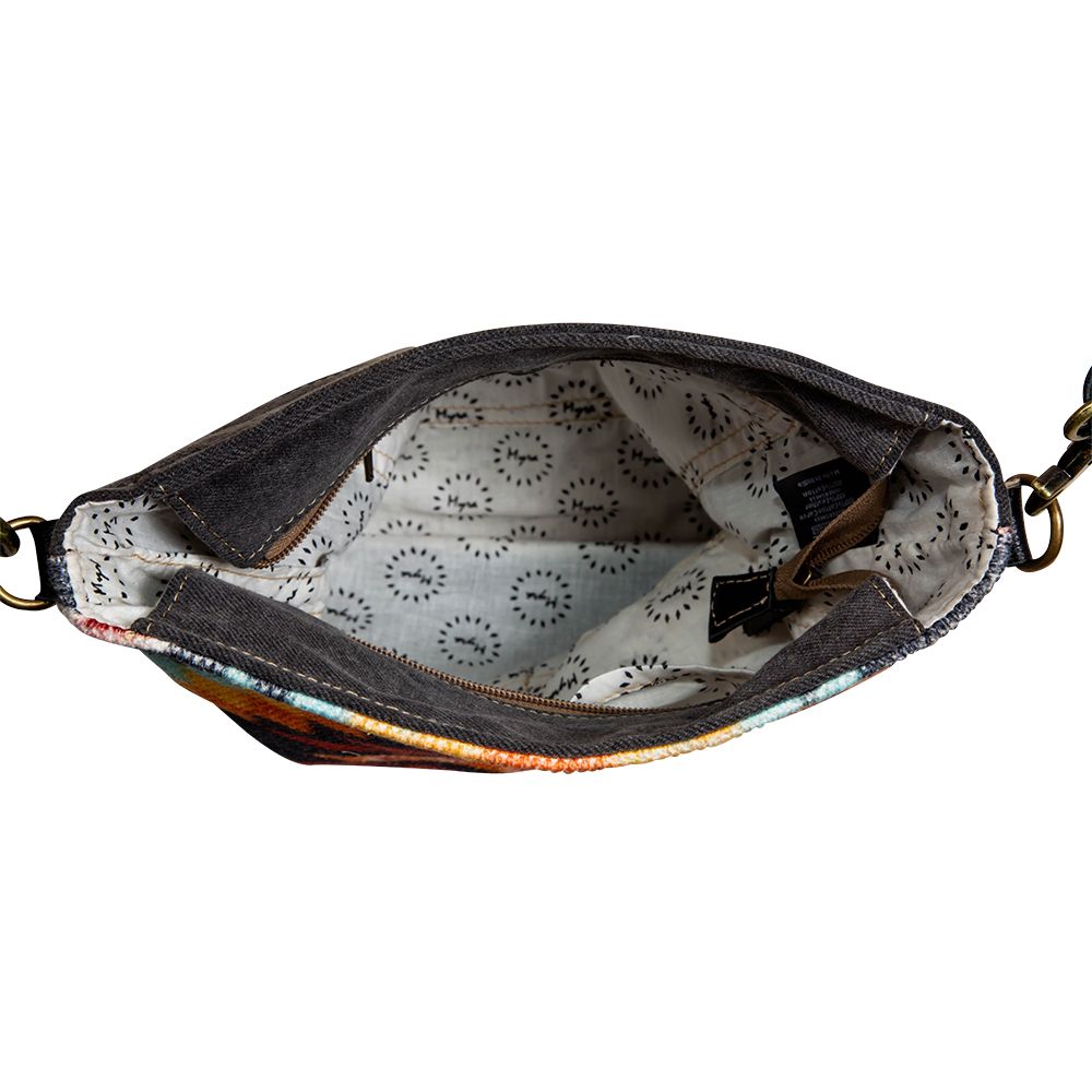 Interior fabric of purse visible with side pockets and zippered top closure open. 