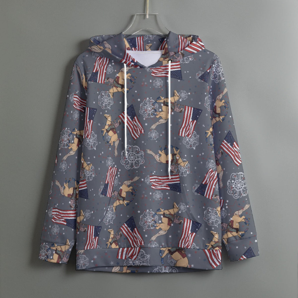 Grey hoodie with Cowboy Christmas with palomino horse and cowgirl running the American flag. Hoodie hangs from a plastic hanger on a grey wall. 