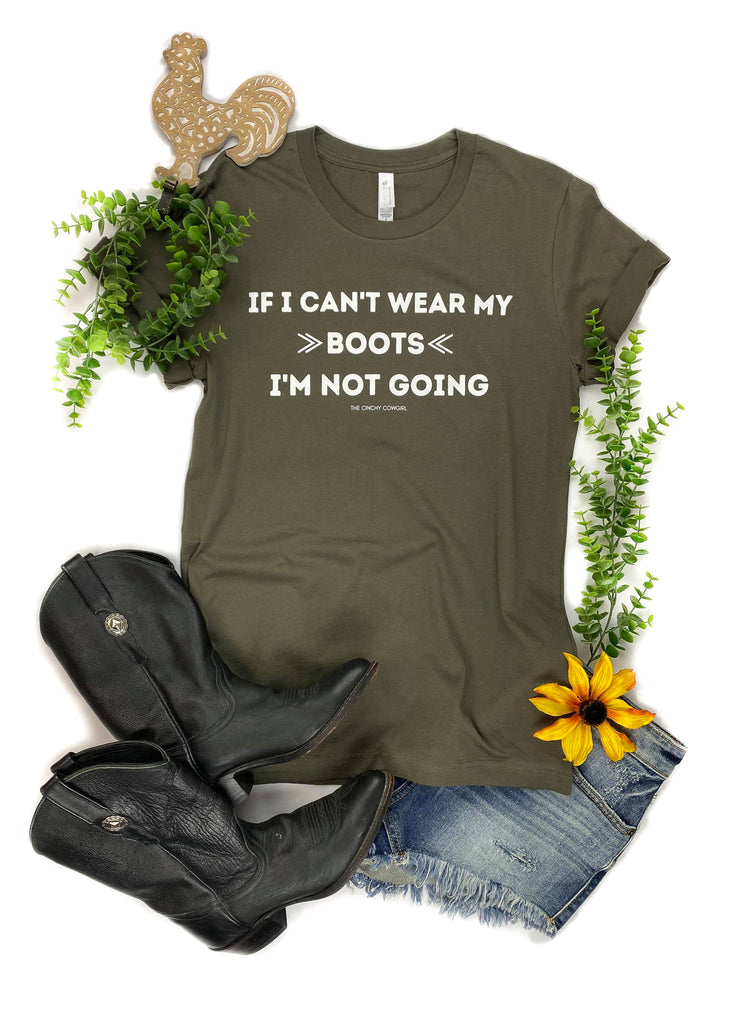 Army Green short sleeve with white lettering that reads "If I Can't Wear My Boots I'm Not Going" with leather boots, jean shorts, greenery, sunflower, and clay rooster.