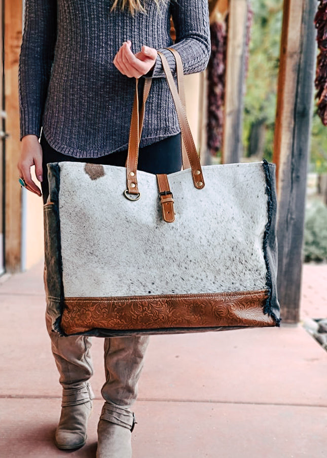 Black & White Cowhide Floral Tooled Weekender Bag [Style C] taken outside on model