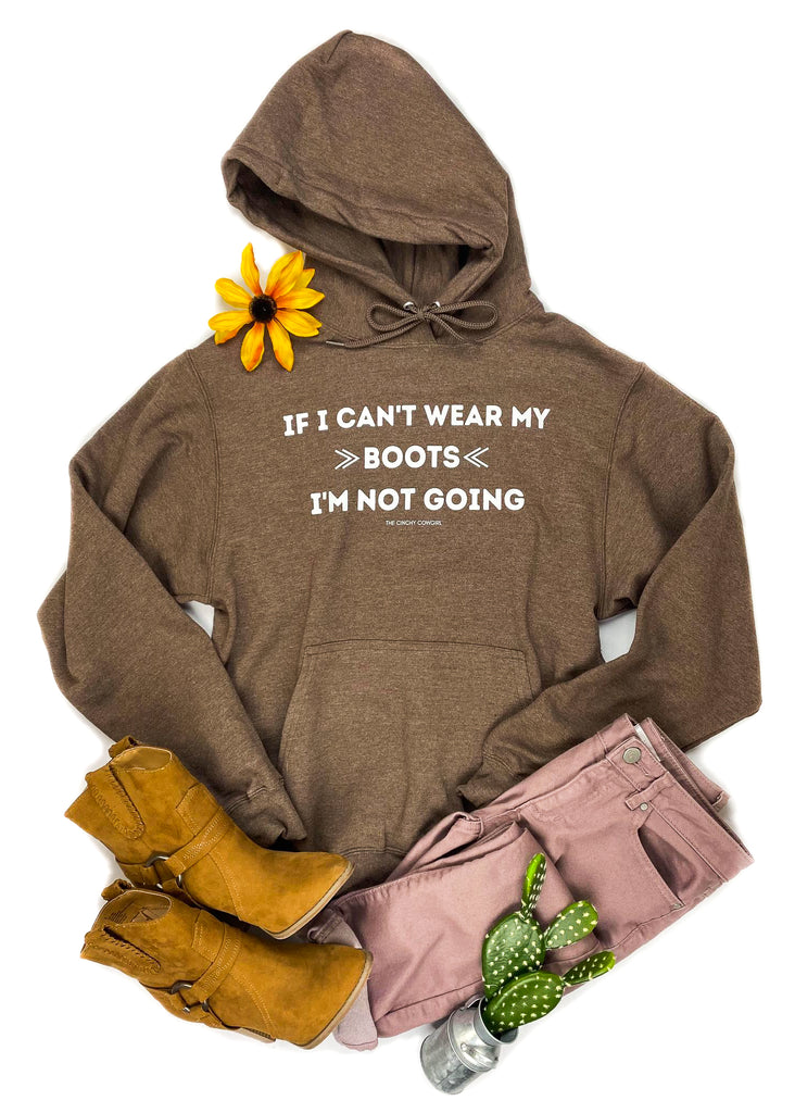 Brown hoodie with white lettering reading "If I can't wear my boots I'm not going".  Mauve colored jeans with mustard color booties with cacti and floral decor. 