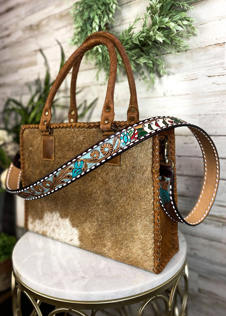 Chips & Cards Purse Strap taken on brown cowhide handbag on white table with green floral décor