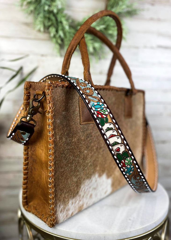 Chips & Cards Purse Strap taken on brown cowhide handbag on white table with green floral décor 