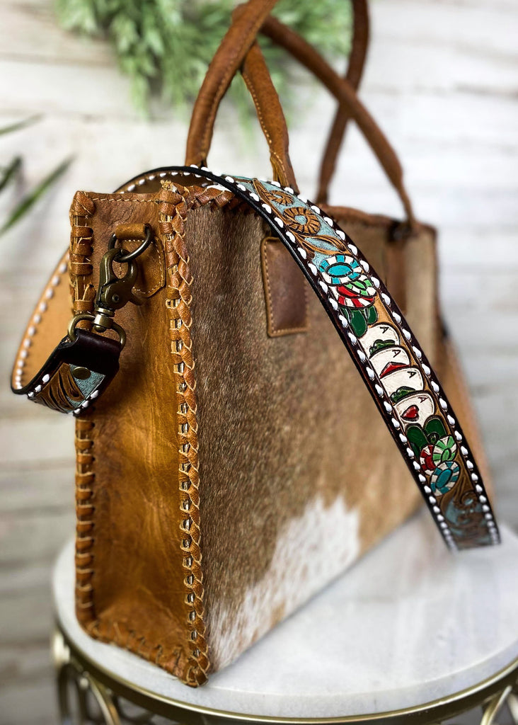 Chips & Cards Purse Strap taken on brown cowhide handbag on white table with green floral décor