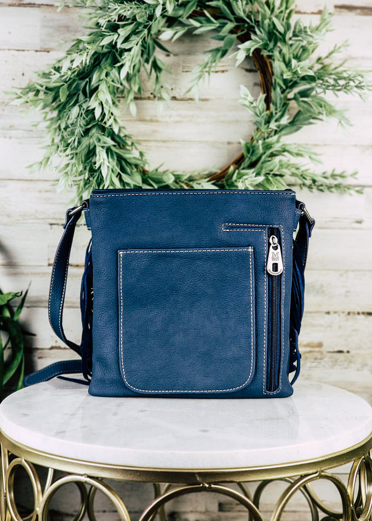 Navy fringe concealed carry backside of the bag with zippered concealed pocket and open pocket on the back. 