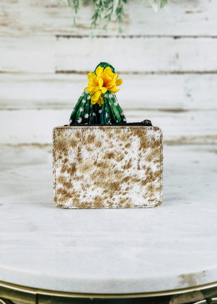 Cowhide card holder with zippered top pocket. Backside solely has cowhide. 