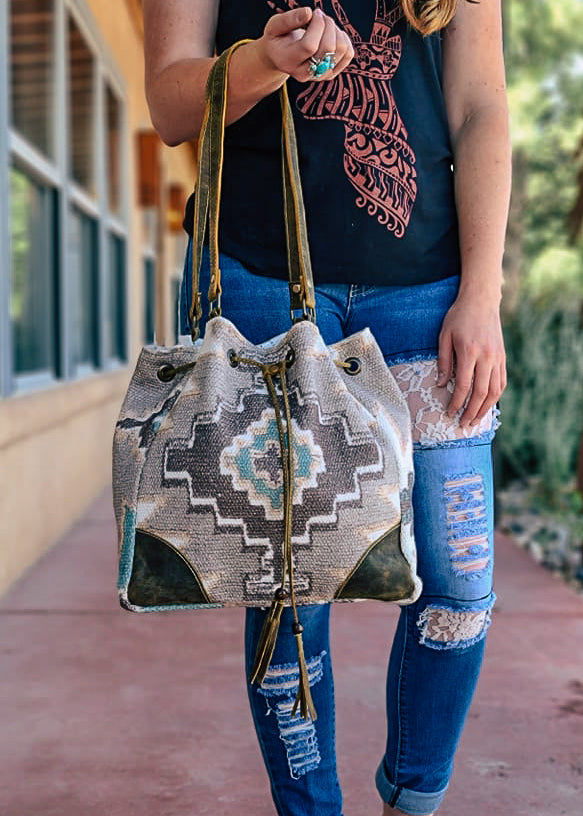 Temple Aztec Bucket Tote Handbag taken outside on model 
