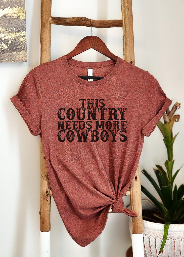 This Country Needs More Cowboys Short Sleeve Tee [4 colors] tcc graphic tee - $19.99 The Cinchy Cowgirl Small Heather Clay 