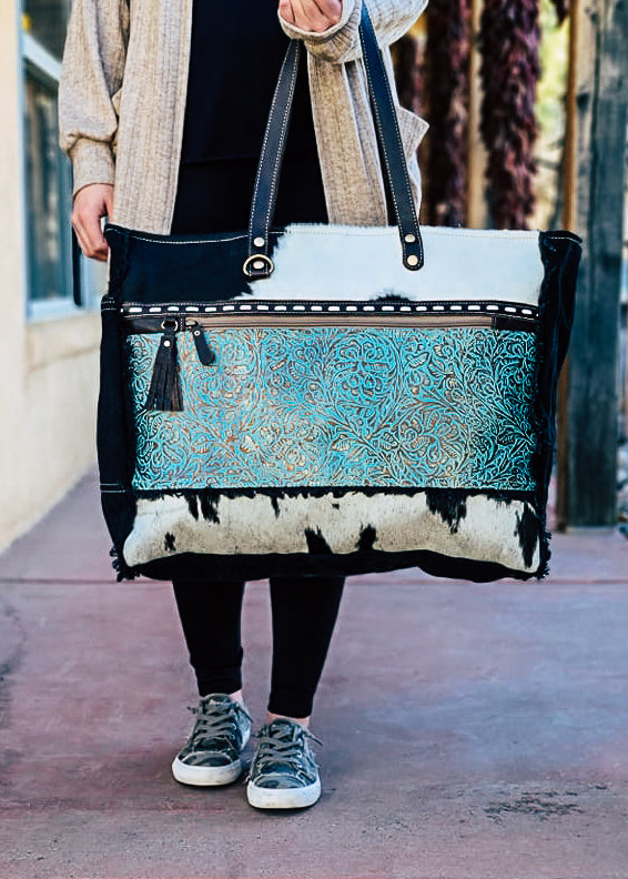 Turquoise Patina Cowhide Weekender Bag on model