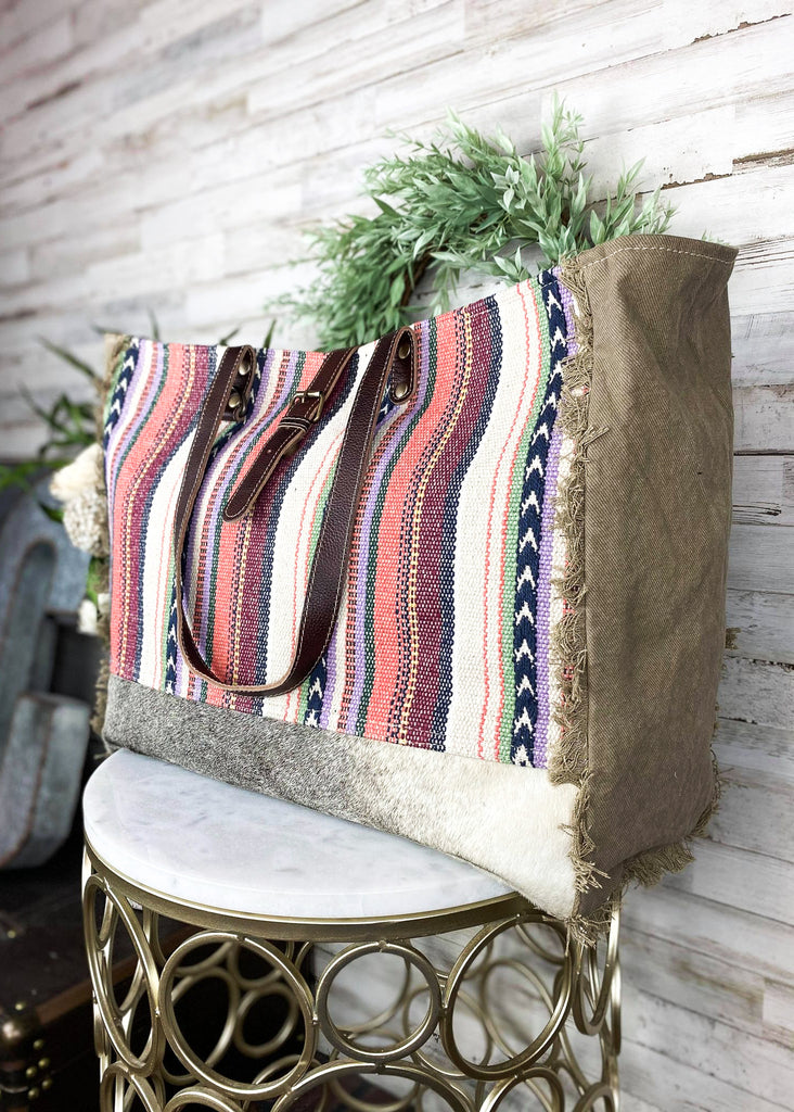 Pastel Hues Aztec Weekender Bag on white table with green decor