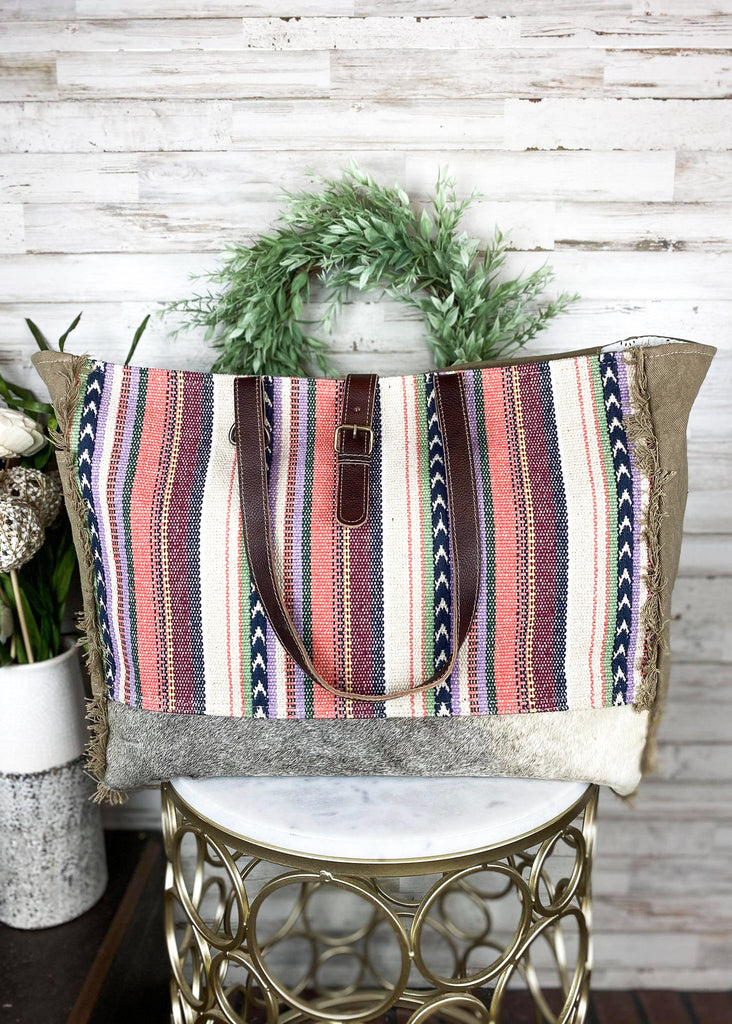 Pastel Hues Aztec Weekender Bag on white table with green decor