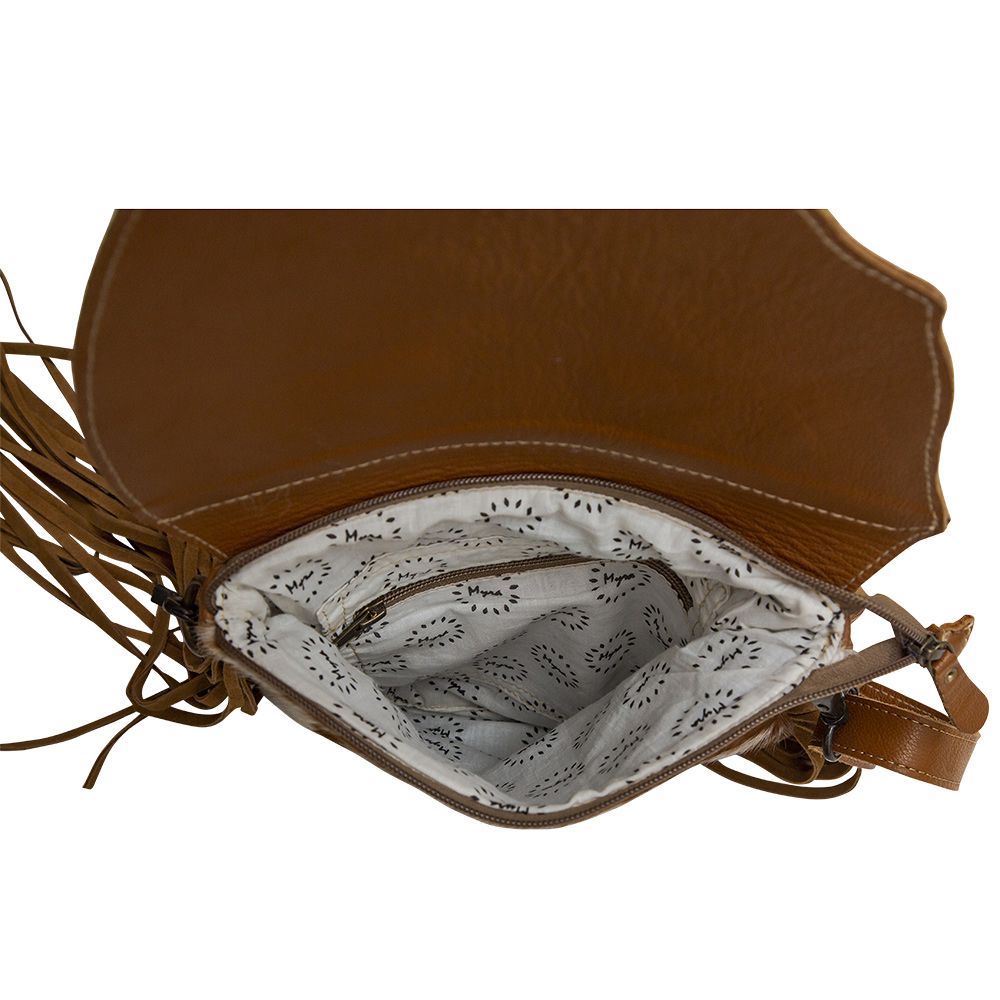Tooled leather flap is open showing the open zippered interior with side zippered pocket. 