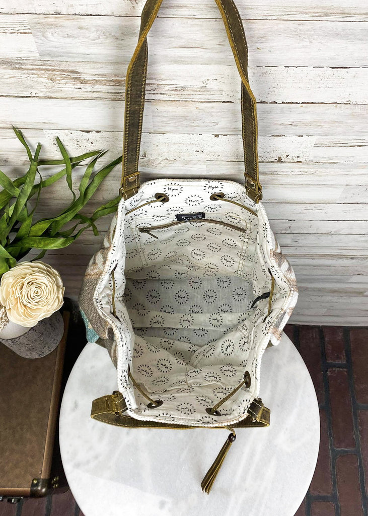 Temple Aztec Bucket Handbag on white table, inside view